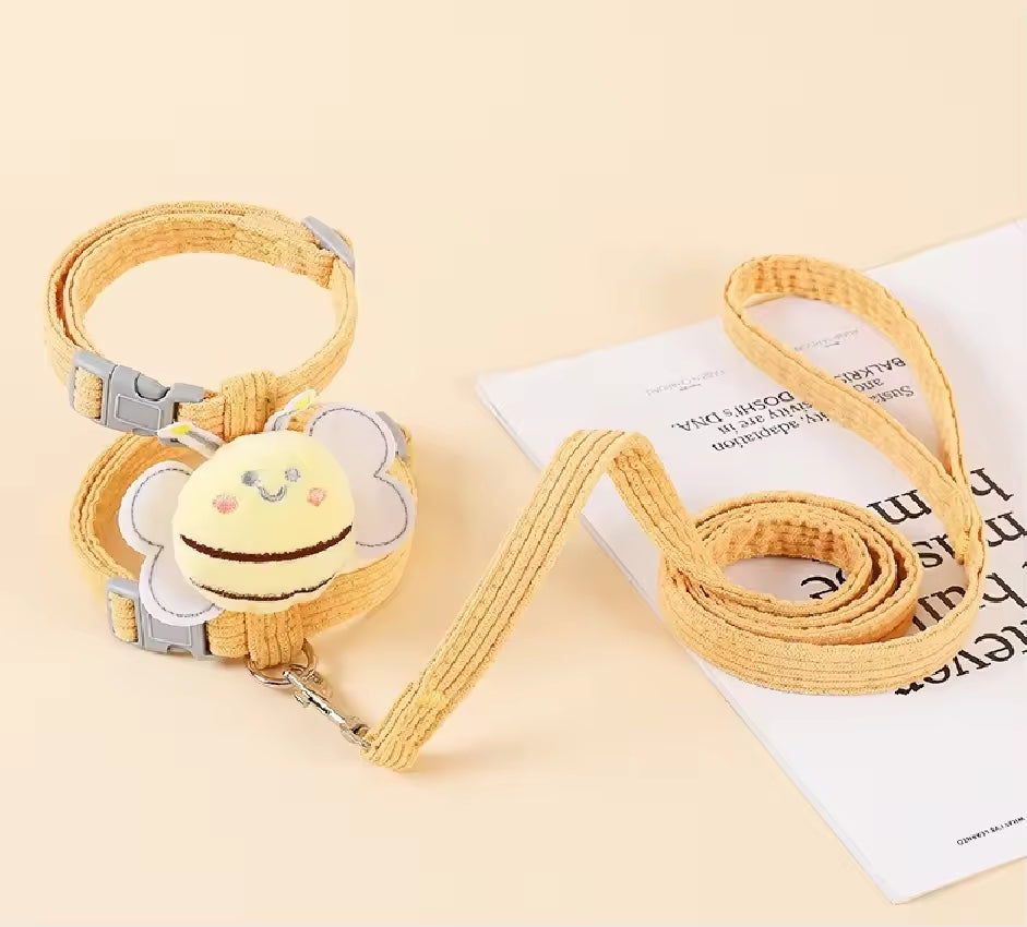 Yellow pet collar and leash set on a light beige background