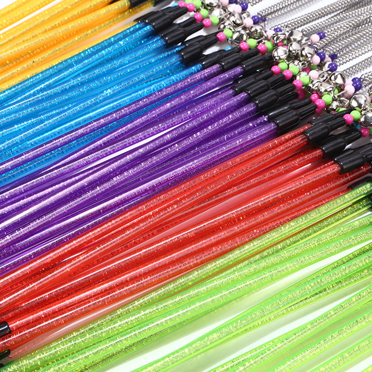 Colorful glittery sticks with beads on a white background