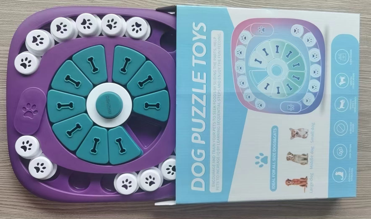 A purple and teal dog puzzle toy shown next to its light blue and white retail box on a light wood surface.