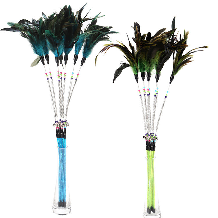Two feathered sticks with colorful beads and feathers on a white background