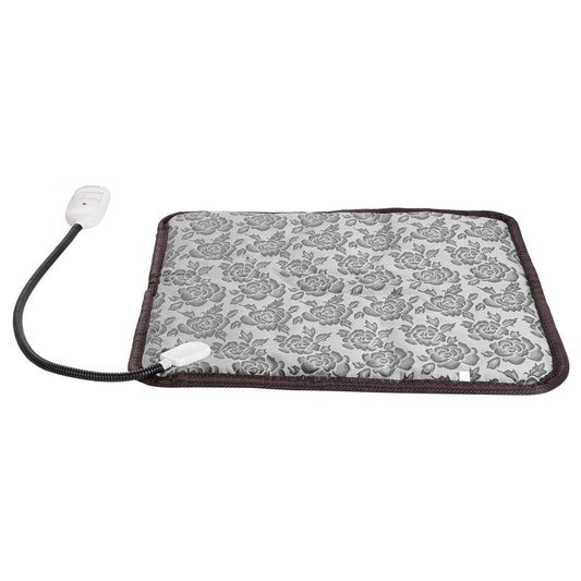 An electric heating pad with a gray and white floral patterned fabric surface, dark brown trim, and an attached black power cord with a white control switch, shown on a plain white background.