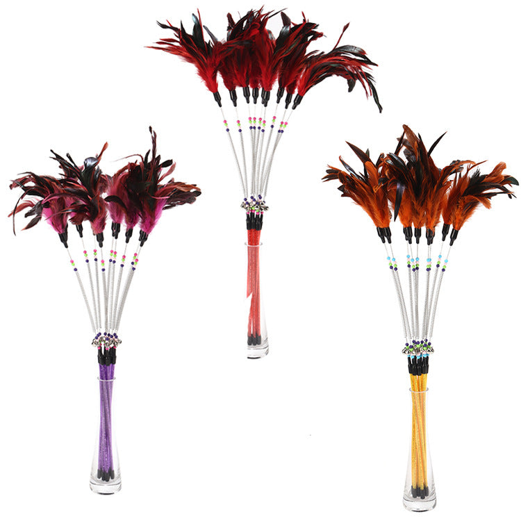 Three feather dusters with different colored handles on a white background