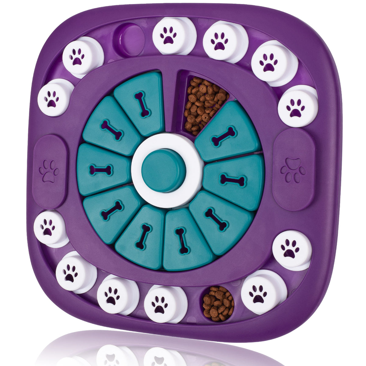 A purple and teal dog puzzle feeder with white paw-print buttons around the edge, shown on a clean white background with a faint reflection below.