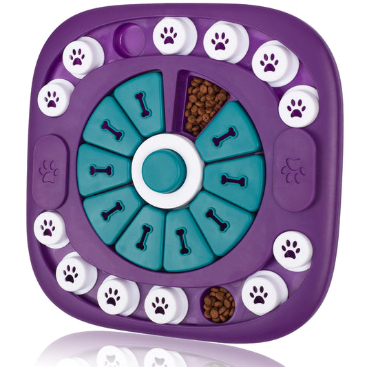 A purple and teal dog puzzle feeder with white paw-print buttons around the edge, shown on a clean white background with a faint reflection below.