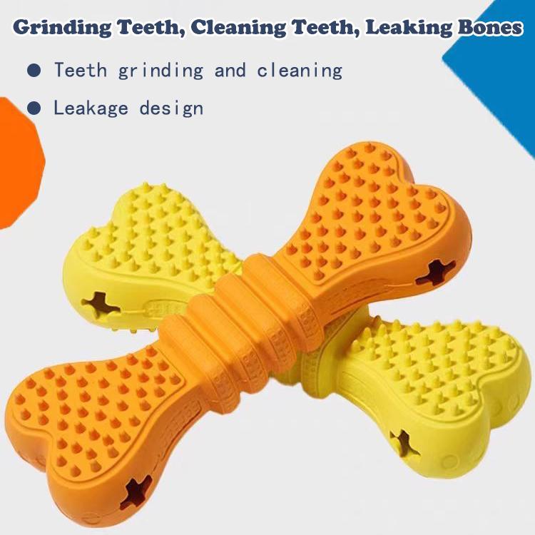 A dog chew toy shaped like a bone, made of textured yellow rubber with orange silicone scrubber ends, shown on a clean white background.