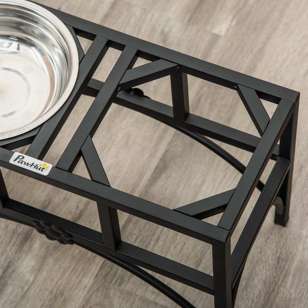 Black pet feeding station with a metal bowl on a wooden floor