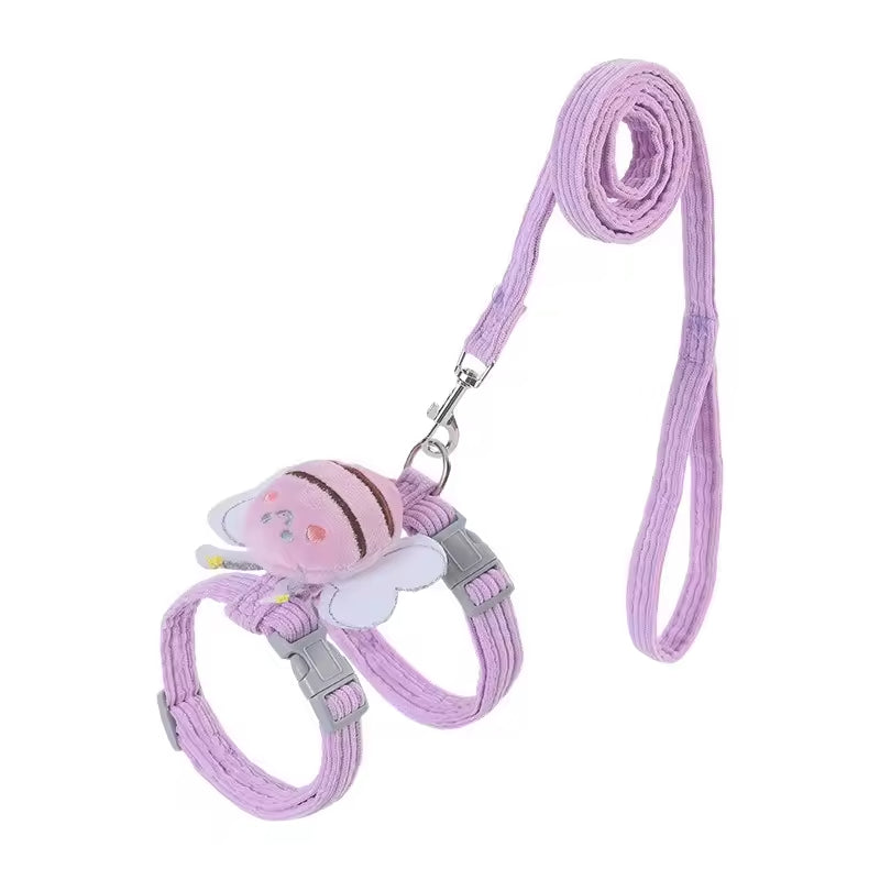 Pink pet harness and leash set with a cartoon character on a white background