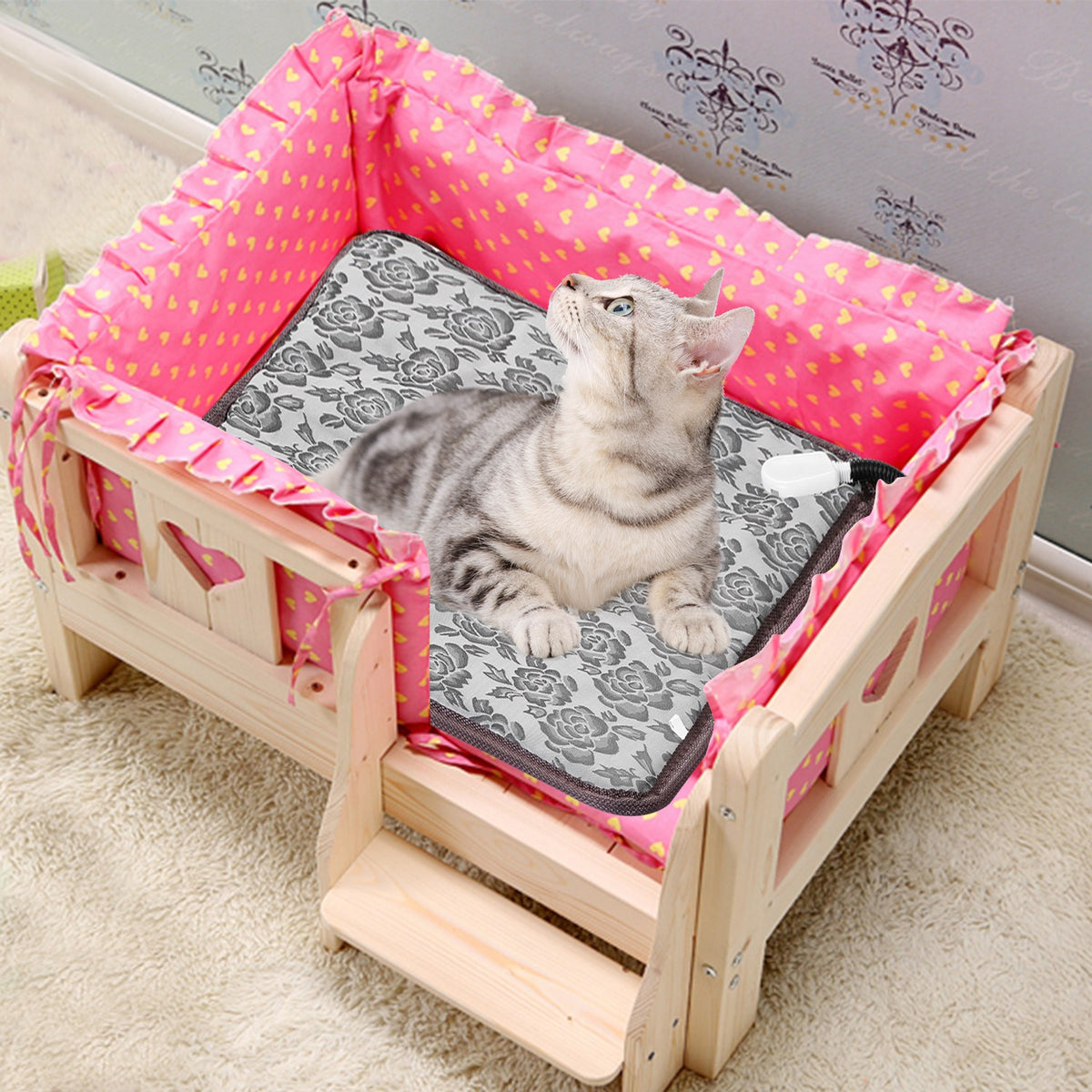 Cat lying on a small wooden bed with pink bedding