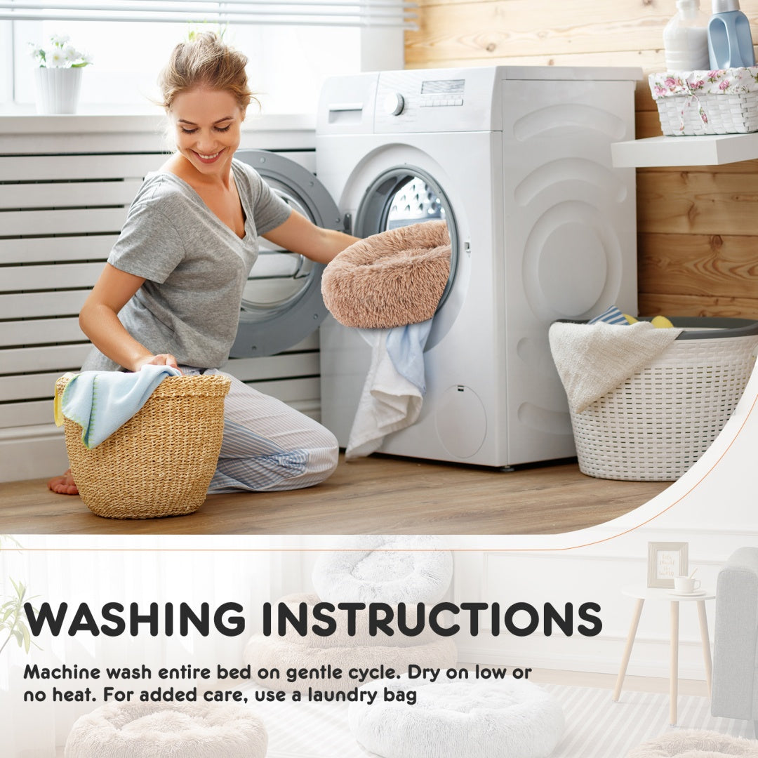 Woman sorting laundry in a modern laundry room with washing instructions displayed.