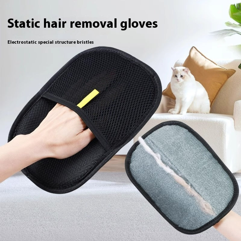 Black static hair removal gloves with a gray bristle side, held by a person, with a cat in the background.