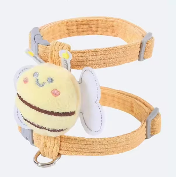 Yellow dog collar with a bee-shaped toy on a white background